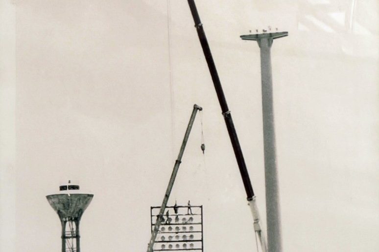 Cranes raising stadium floodlight masts, from the Al Fahd archive